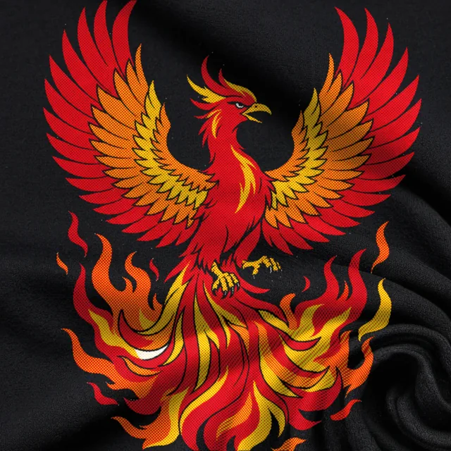 Close-up of a black T-shirt printed with a red and gold phoenix in bold round halftone dots.